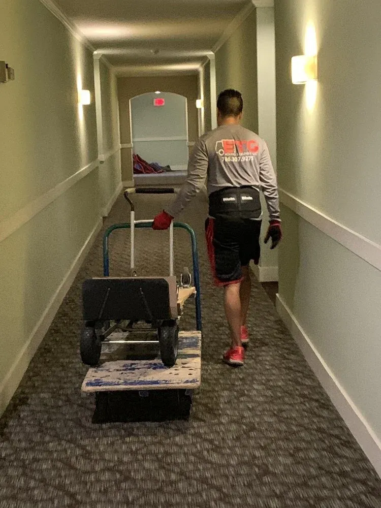 ETG mover pushing a dolly down a condo hallway
