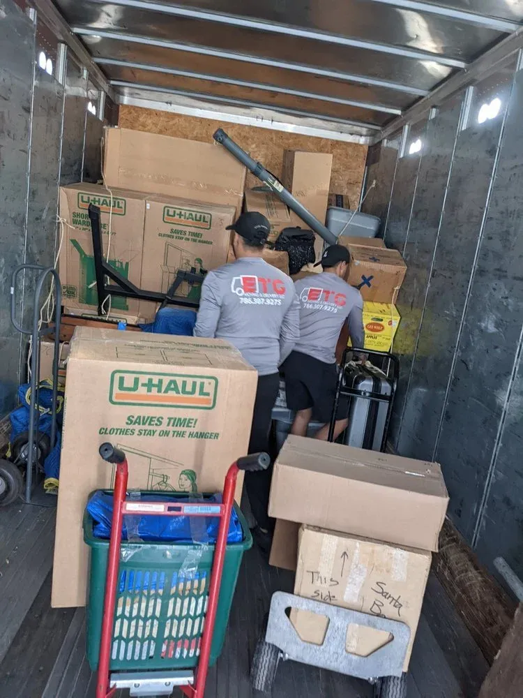 ETG crew in company shirts loading boxes into the truck