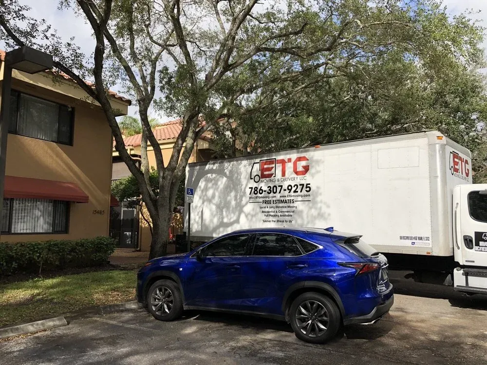 ETG Moving & Delivery truck parked at a Miami residential complex